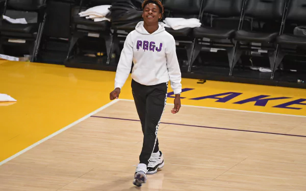 Hoops enthusiast walking on basketball court for HD desktop wallpaper background.