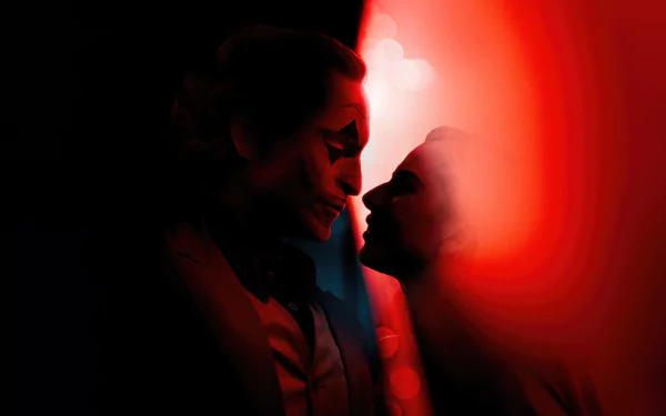HD desktop wallpaper featuring a stylized artistic representation related to the movie Joker: Folie à Deux, depicting two silhouettes with Joker-like makeup in red and black tones, facing each other intimately against a dark background.
