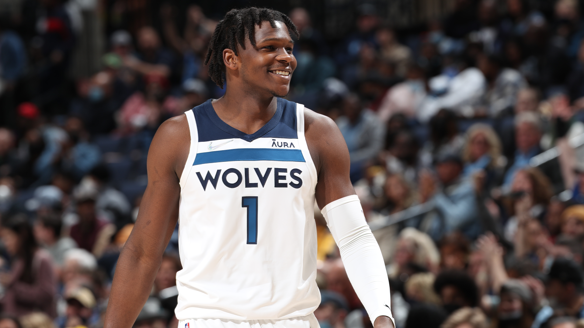 HD desktop wallpaper of Anthony Edwards, Minnesota Timberwolves player, smiling on the court in his white Wolves uniform.