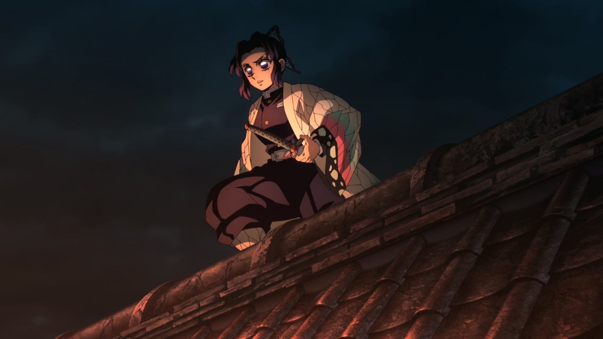 Demon Slayer: Kimetsu no Yaiba anime HD PC wallpaper featuring Shinobu Kochou crouched on a rooftop at night, warm roof tiles glowing beneath her against a dark, moody sky.