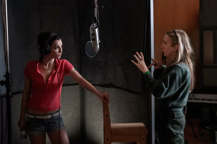HD desktop wallpaper from the movie Back to Black, featuring Amy Winehouse in a recording studio with another person.