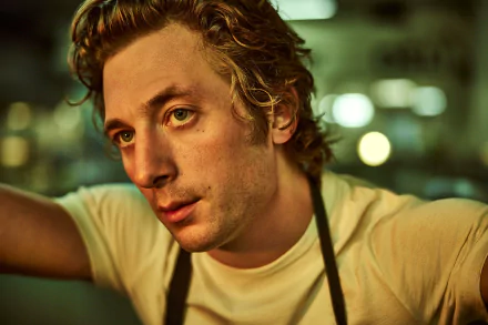 HD desktop wallpaper featuring Jeremy Allen White from the TV show The Bear, captured in a candid moment with a blurred background.