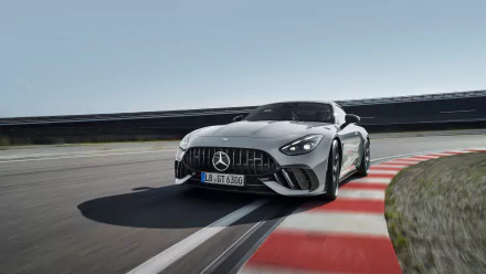 HD desktop wallpaper featuring a sleek Mercedes-AMG GT63 PRO car taking a sharp turn on a racetrack.