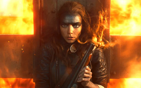 A desktop wallpaper featuring a character from the movie Furiosa: A Mad Max Saga portrayed by an actress, with determined expression, wearing dark eye makeup and rugged attire, holding a weapon, against a fiery background.