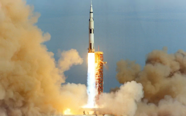 HD desktop wallpaper of a Saturn V rocket launching, surrounded by clouds of smoke and flames.