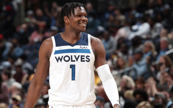 HD desktop wallpaper of Anthony Edwards, Minnesota Timberwolves player, smiling on the court in his white Wolves uniform.
