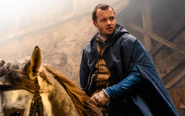 HD wallpaper of a scene from the TV show Shardlake, featuring a man in historical attire beside a horse in a foggy stable setting.