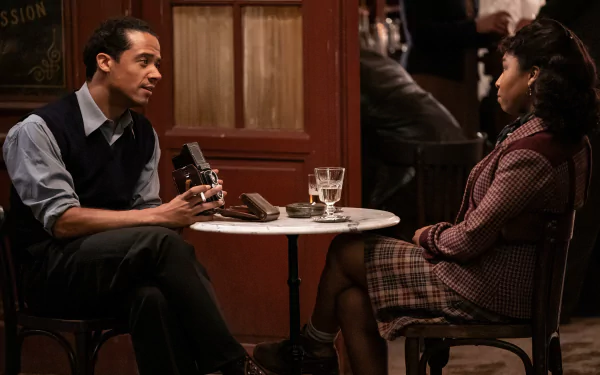 HD wallpaper featuring two characters from Interview with the Vampire TV show, engaged in an intense conversation at a café table.