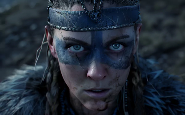 HD desktop wallpaper and background of Senua from the video game Senua's Saga: Hellblade II featuring a close-up of her intense gaze, facial markings, and detailed costume.