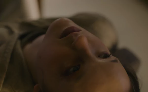 Close-up of a woman lying down with a somber expression, captured in 8K Ultra HD as a PC desktop wallpaper background inspired by The Last Of Us.
