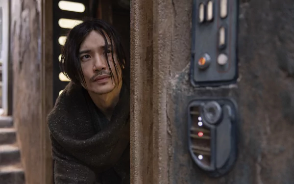 HD desktop wallpaper featuring a scene from the TV show The Acolyte (2024), showing a character peeking out from a doorway beside a futuristic control panel.