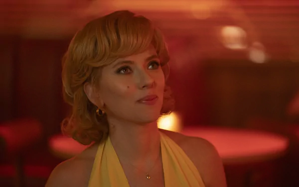 HD desktop wallpaper featuring Scarlett Johansson in the movie Fly Me to the Moon (2024), set against a warmly lit background.