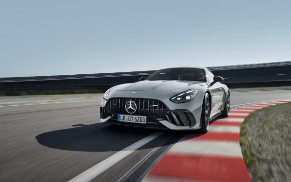 HD desktop wallpaper featuring a sleek Mercedes-AMG GT63 PRO car taking a sharp turn on a racetrack.