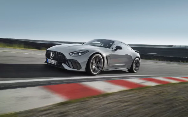 An HD desktop wallpaper and background featuring a silver Mercedes-AMG GT63 PRO speeding on a race track, showcasing its sleek design and performance.