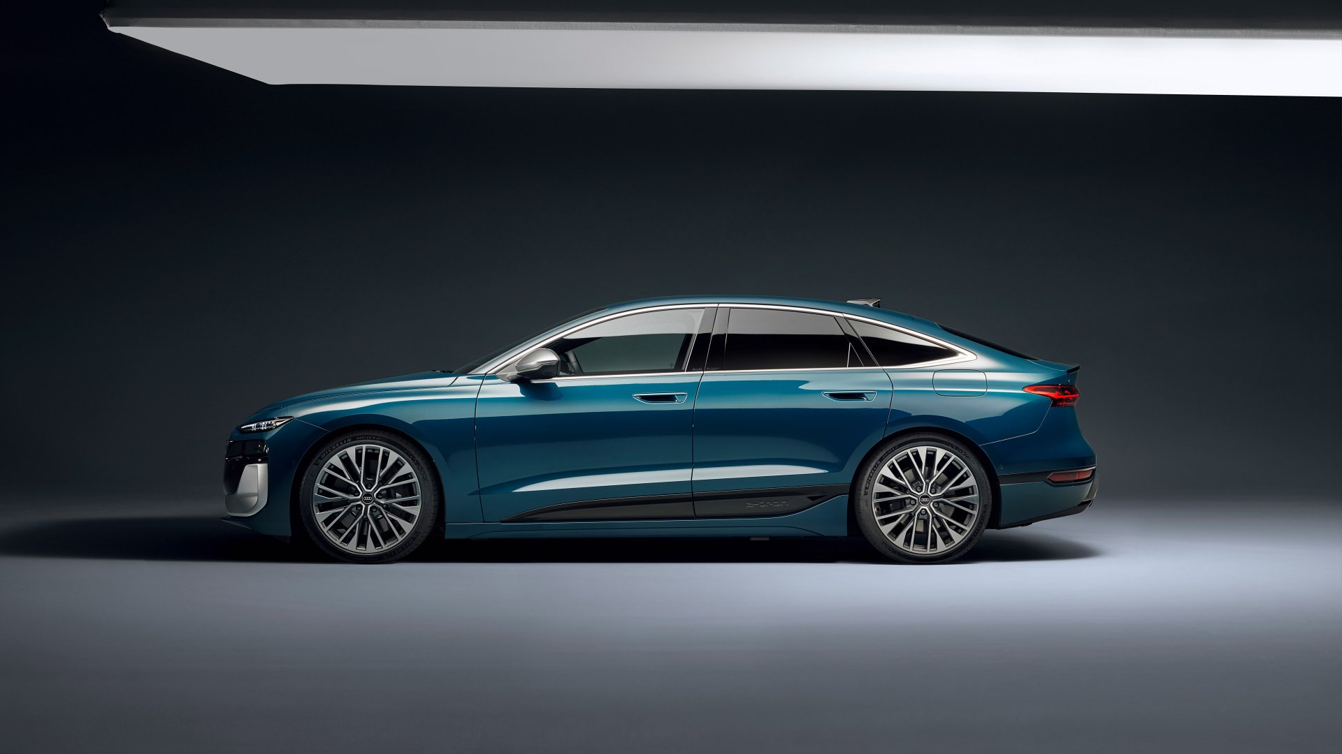 A sleek Audi S6 E-Tron is prominently featured in this HD desktop wallpaper, showcasing its modern design and innovative features against a stylish backdrop.