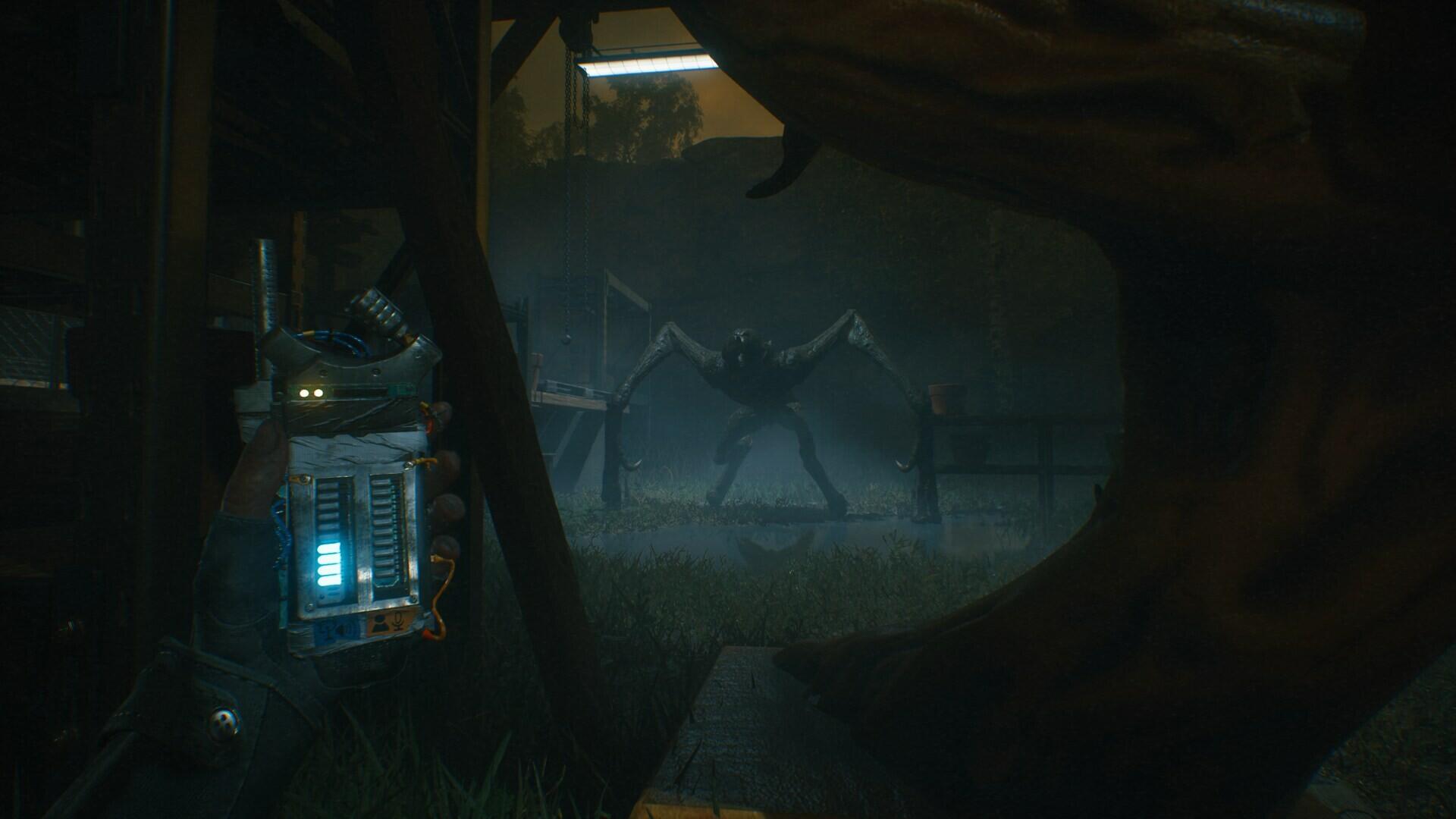 HD PC desktop wallpaper featuring a tense scene from the video game A Quiet Place: The Road Ahead, showcasing a dark cavern with a glowing-eyed device and a looming creature.