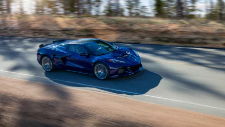 A striking Chevrolet Corvette ZR1 in a dynamic pose, captured on an open road, serving as a stunning HD desktop wallpaper and background.