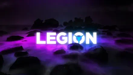 A vibrant HD desktop wallpaper featuring the word LEGION illuminated in bright white against a dark, rocky background with purple and blue hues, showcasing Lenovo's tech branding.