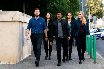 A group of five agents from the TV show FBI: International confidently walks down a city street, showcasing determination and teamwork against a vibrant urban backdrop.