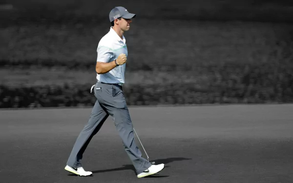 HD desktop wallpaper featuring golfer Rory McIlroy in action on the golf course, capturing his dynamic swing and focus in a pristine sports setting.