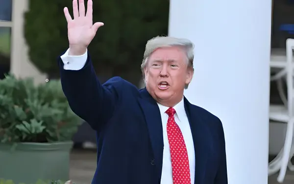 HD desktop wallpaper featuring Donald Trump waving, embodying the MAGA spirit with a confident expression against an outdoor background.