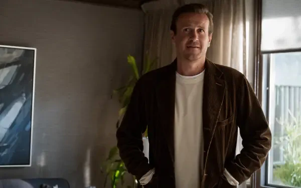 A still from the TV show Shrinking featuring Jason Segel, portraying a relaxed moment indoors with a modern aesthetic. 4K Ultra HD desktop wallpaper.