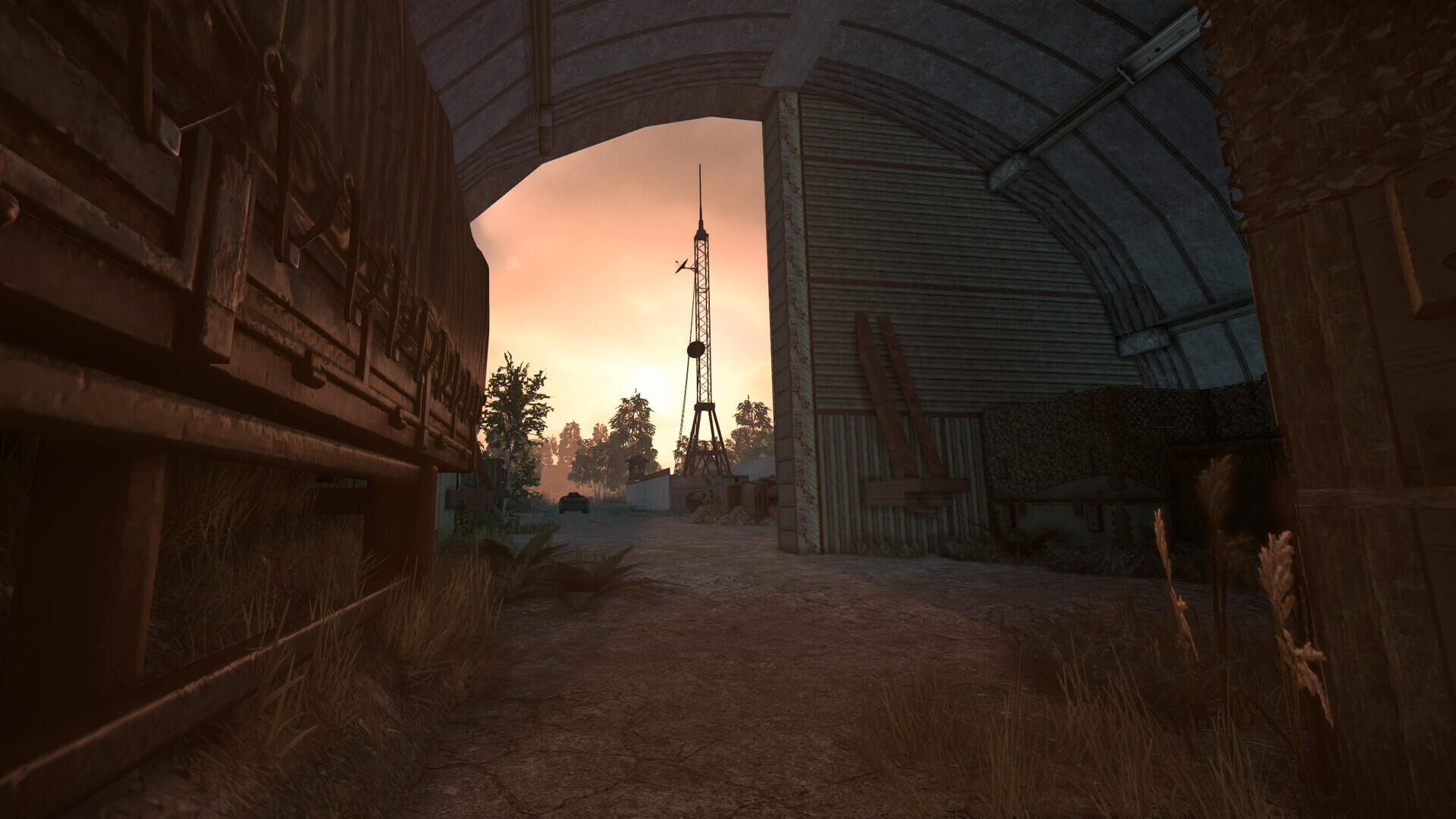 A captivating HD PC desktop wallpaper from STALCRAFT: X, showcasing an industrial landscape at dusk with a silhouette of a radio tower and abandoned structures.