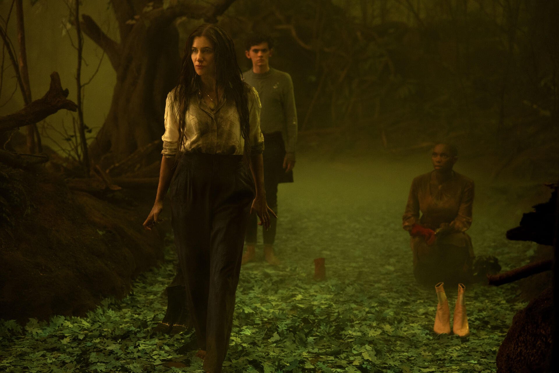 A mystical scene from the TV show Agatha All Along, featuring three characters walking through a foggy, enchanted forest, embodying an eerie atmosphere in stunning 4K Ultra HD.