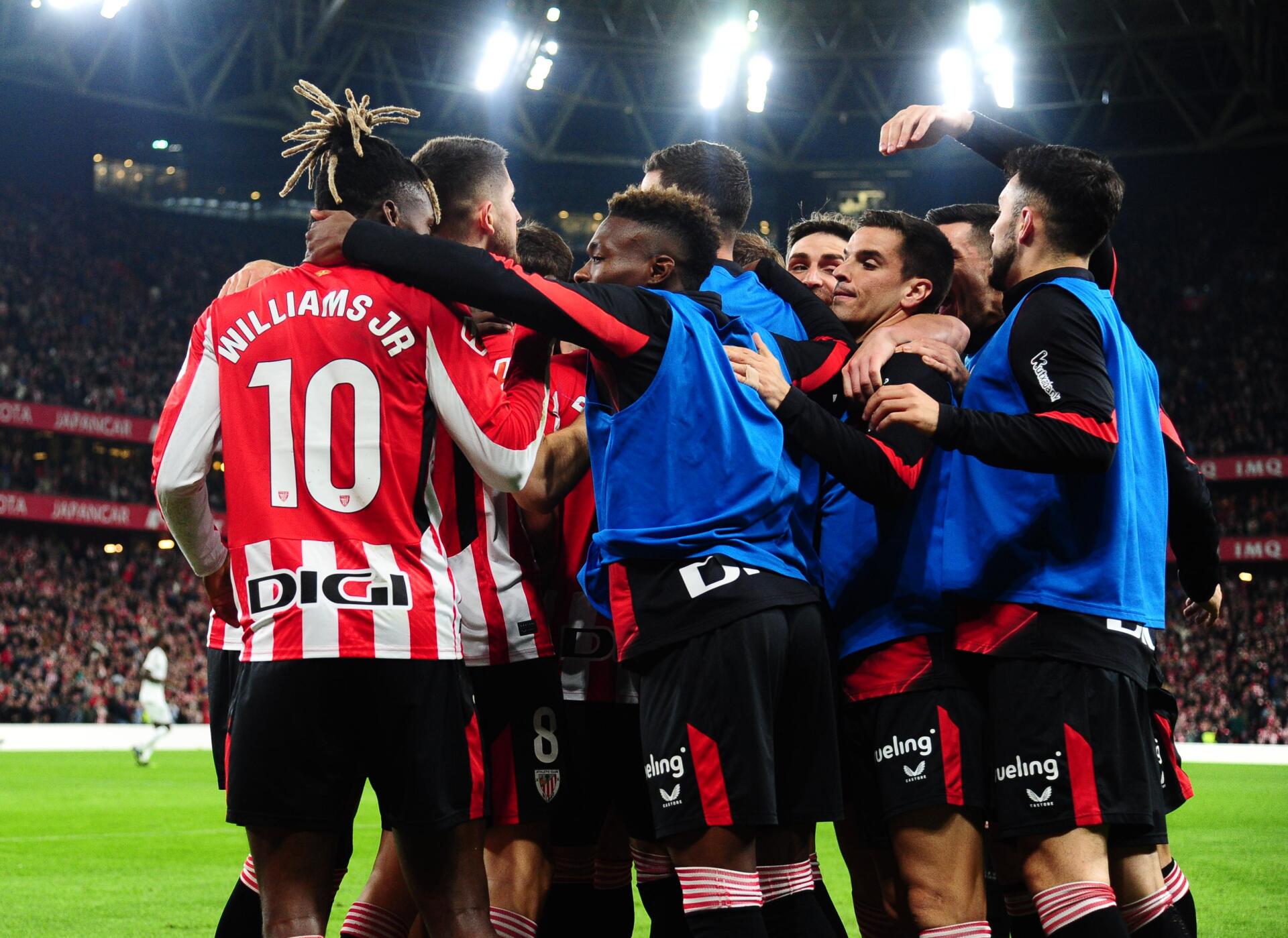 Athletic Club soccer players celebrating on the field during a match, captured in an HD PC desktop wallpaper with vibrant stadium lighting.