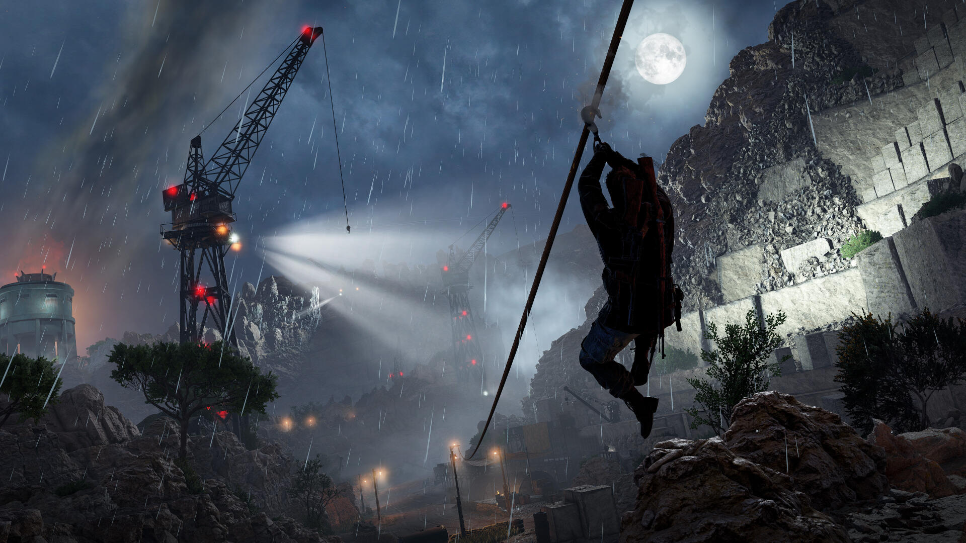A dramatic scene from Sniper Elite: Resistance, featuring a silhouetted figure climbing a rope amidst a stormy night, illuminated by searchlights and construction cranes in the background.