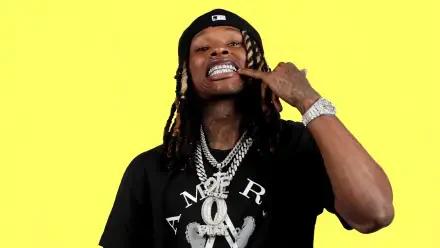 A vibrant HD wallpaper featuring rapper King Von, showcasing his signature confident pose, adorned with flashy jewelry against a bright yellow background.