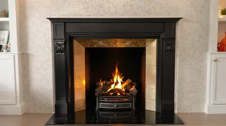 A cozy fireplace with a crackling fire, framed in an elegant black mantle, serves as a warm focal point in this 4K Ultra HD PC desktop wallpaper and background.