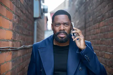 Colman Domingo, starring in the TV show The Madness, is featured in this HD wallpaper, captured in a narrow alley while talking on his phone.