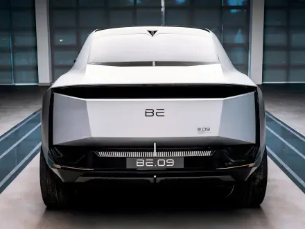 Rear view of a sleek Mahindra BE 09 car in a modern setting, featured as an HD PC desktop wallpaper and background.