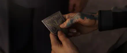 A close-up of a hand holding a detailed metal insignia, set against a blurred background, from the video game Exodus (2024), making a striking HD desktop wallpaper.