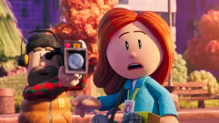 A scene from the animated movie Dog Man (2025) features a surprised woman with red hair, while a man with a camera captures the moment against a colorful backdrop.