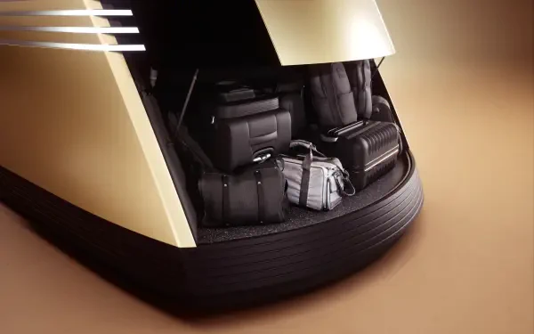 A close-up view of a Tesla robovan's spacious interior, showcasing neatly organized luggage and bags, set against a sleek design. This 8K Ultra HD image serves as a stunning desktop wallpaper.