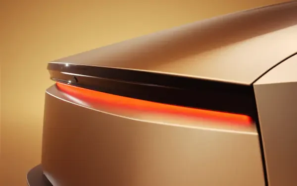 A sleek, close-up view of a Tesla Cybercab's rear, highlighting its futuristic design and illuminated taillight. The image serves as an 8K Ultra HD wallpaper.