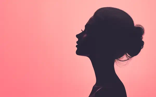 A feminine silhouette of a woman against a soft pink background, featured as a striking 4K Ultra HD PC desktop wallpaper and background.