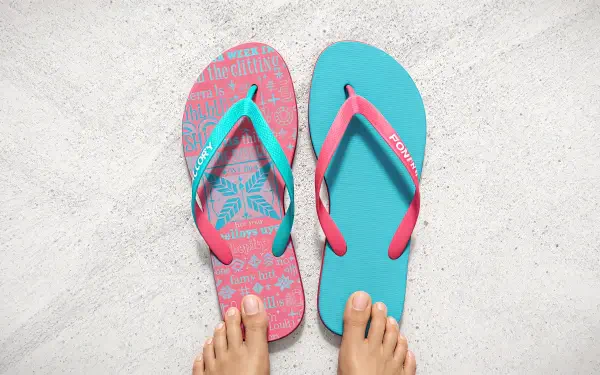 Close-up of vibrant flip flops in pink and teal, placed on a light surface, complemented by bare feet. This image serves as a colorful 4K Ultra HD desktop wallpaper and background.