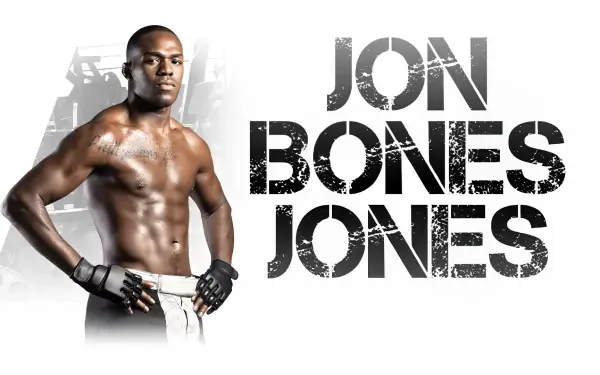 HD wallpaper featuring Jon Jones, a prominent UFC and MMA fighter, showcasing his athletic physique and gritty determination against a dynamic gym backdrop.