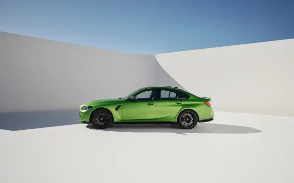A striking green BMW M3 stands elegantly against a minimalist white backdrop, showcased in high-resolution 4K Ultra HD for an impressive desktop wallpaper.