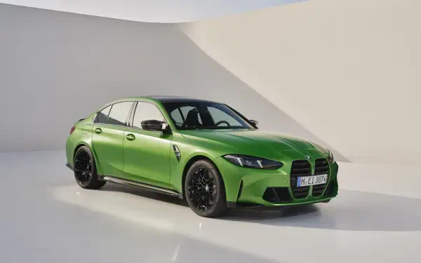 A striking green BMW M3 parked against a minimalist backdrop, showcasing its sleek design and powerful presence in this 4K Ultra HD desktop wallpaper.