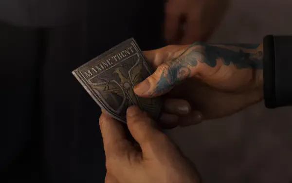A close-up of a hand holding a detailed metal insignia, set against a blurred background, from the video game Exodus (2024), making a striking HD desktop wallpaper.