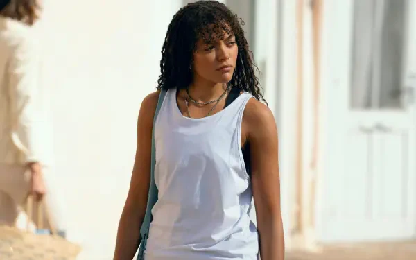Quintessa Swindell from the TV show Prime Target stands outdoors, wearing a white tank top, captured in an 8K Ultra HD PC desktop wallpaper and background.
