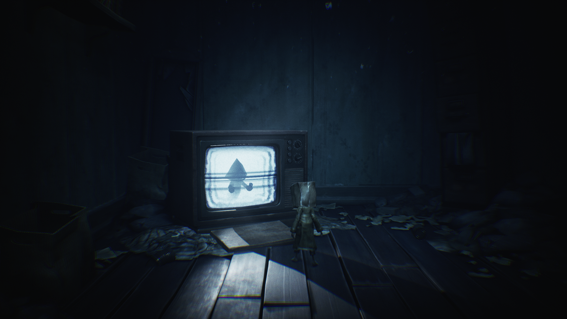 A dark, atmospheric HD wallpaper from Little Nightmares features Six standing in a dim room, with an old television casting eerie light amidst scattered debris.
