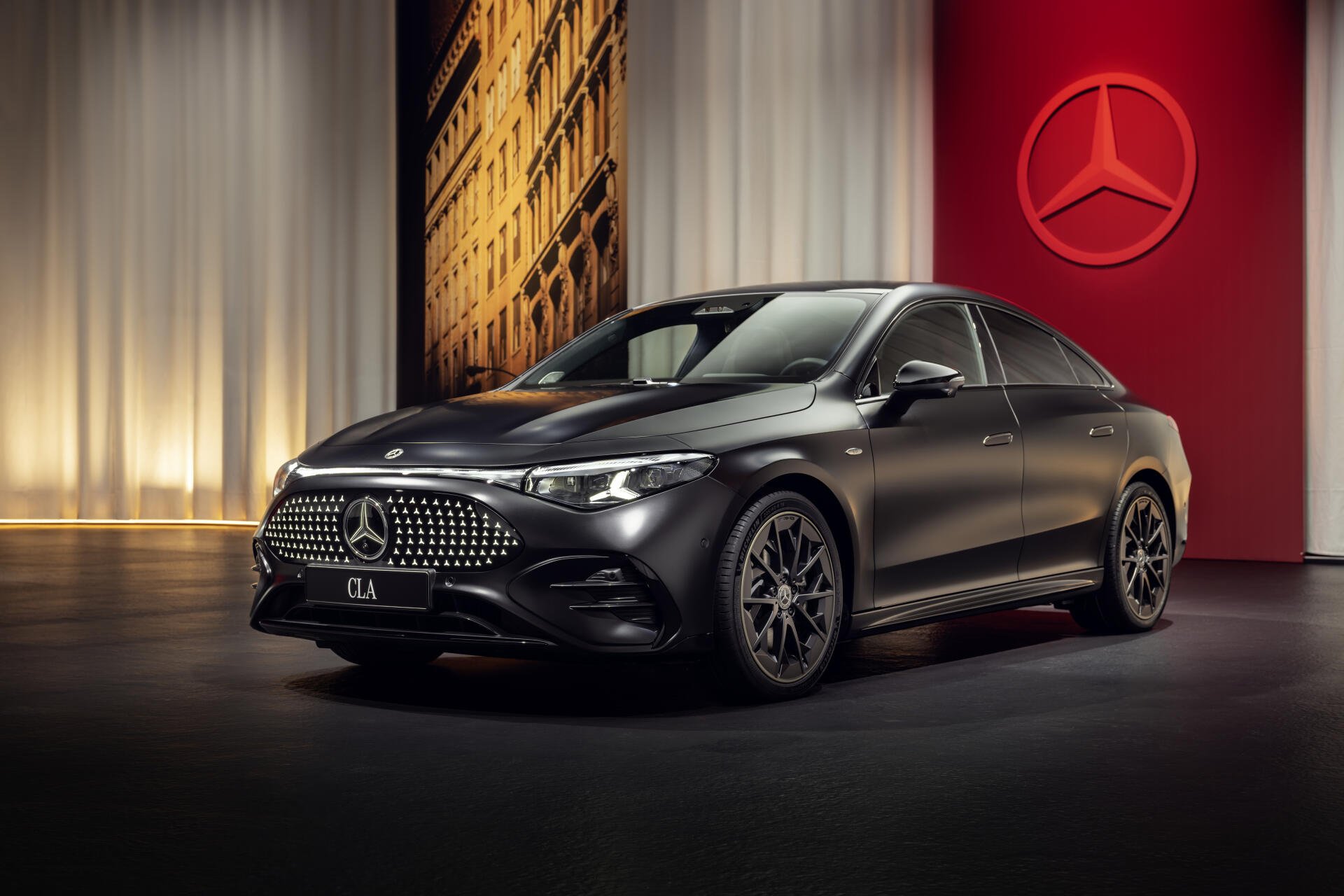 A sleek black Mercedes-Benz CLA showcased in an elegant setting, highlighting its luxury design and distinctive front grille, set against a rich backdrop.