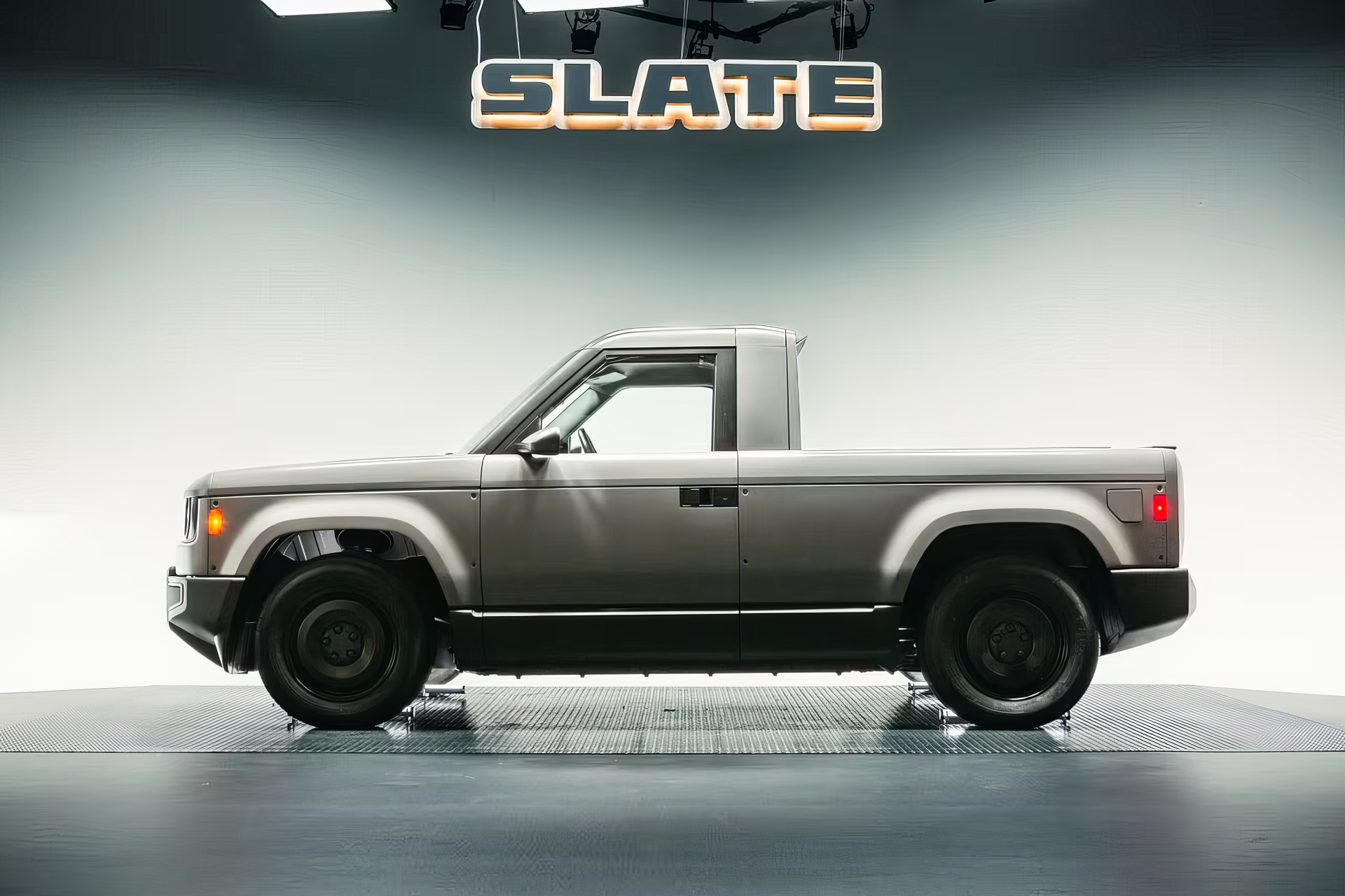 HD PC desktop wallpaper featuring a sleek Slate Auto truck in a minimalist studio setting, highlighting the Slate brand and vehicle design.