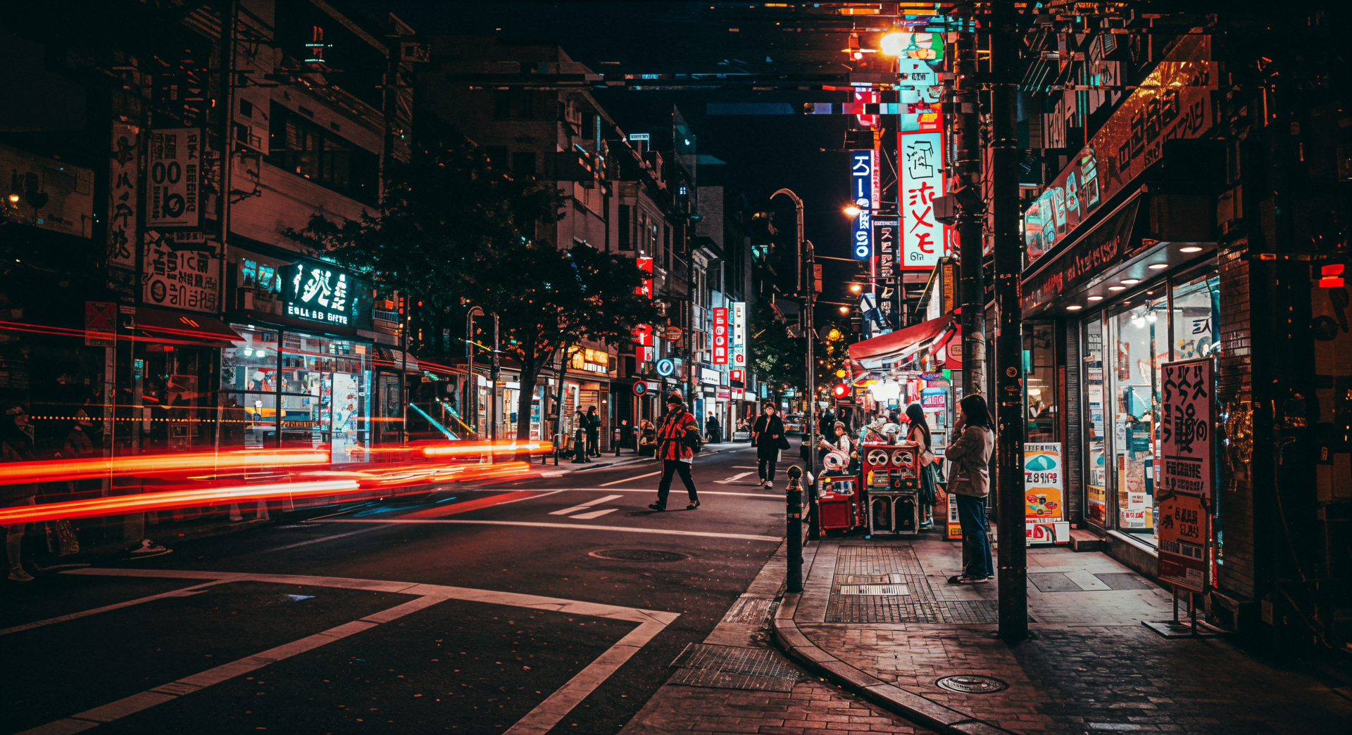 A vibrant street scene at night, featuring illuminated signs and bustling pedestrians, captured in stunning detail, showcasing urban life in 4K Ultra HD as a desktop wallpaper.