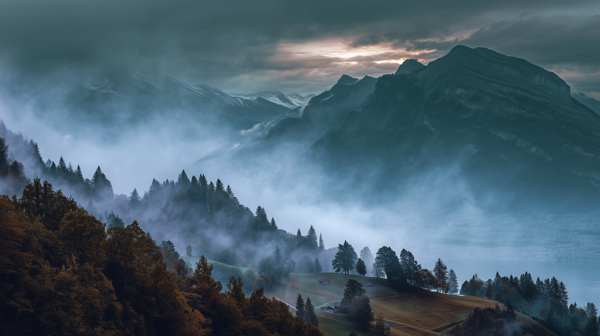 HD desktop wallpaper featuring a foggy mountain landscape with dense trees enveloped in mist under a moody sky.